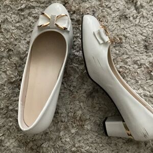 Cute white shoes with bow. Has rhinestones..